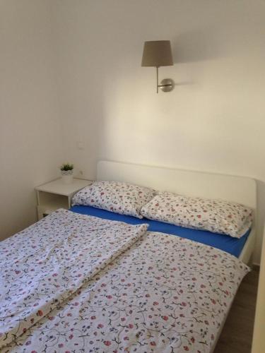 a bedroom with two beds and a table with a lamp at Apartments by the sea Dramalj, Crikvenica - 5597 in Dramalj