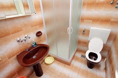 a bathroom with a sink and a toilet at Triple Room Supetar 5658b in Supetar