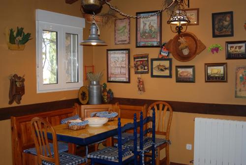 a dining room with a blue table and chairs at Casa Rural Rincon de la Vega in Los Cortos