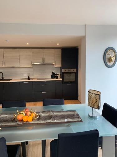 a kitchen with a table with a bowl of fruit on it at Villa Le Brame in Ciney