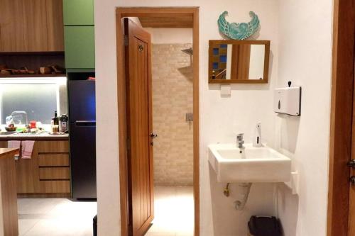 a small kitchen with a sink and a refrigerator at Villa Bale Damai Denpasar in Seminyak
