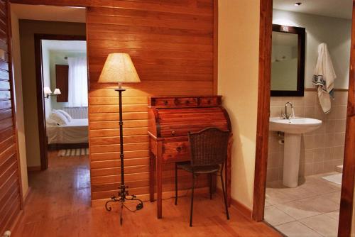 a bathroom with a desk and a sink and a lamp at Cal Puro in Castellnou de Seana