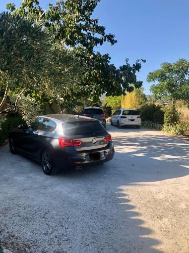 a black car parked in a parking lot at Le Mas Justin in Gordes