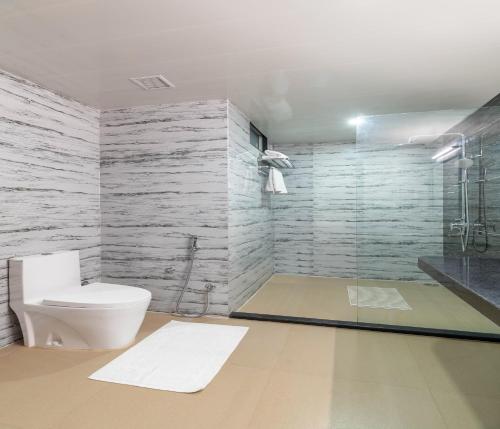 a bathroom with a toilet and a shower in it at Hotel Paandora Grand,Udaipur in Udaipur