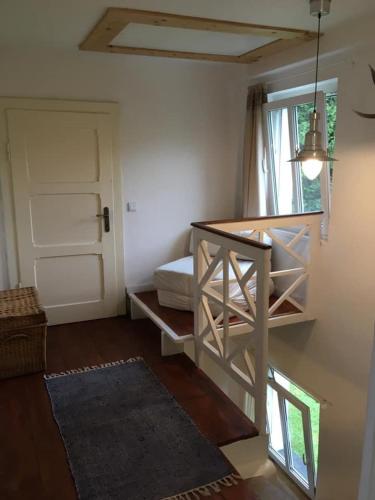 a room with a staircase with a bed and a door at Chalupa Magistrála in Horní Blatná