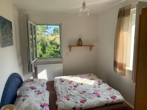 a bedroom with a bed and a window at Chalupa Magistrála in Horní Blatná