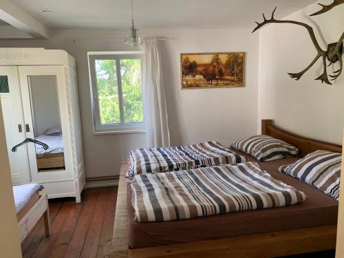 a bedroom with two beds and a window at Chalupa Magistrála in Horní Blatná