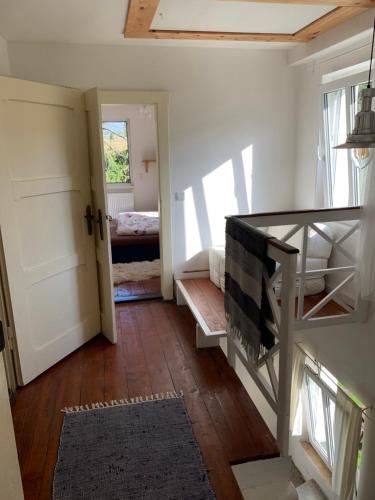 a room with a hallway with a door and a room with a bed at Chalupa Magistrála in Horní Blatná