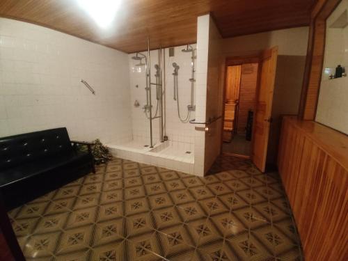 a large bathroom with a shower and a walk in shower at EXCLUSIVE HOUSE 400m2 - Sauna, BBQ, fireplace in Narva