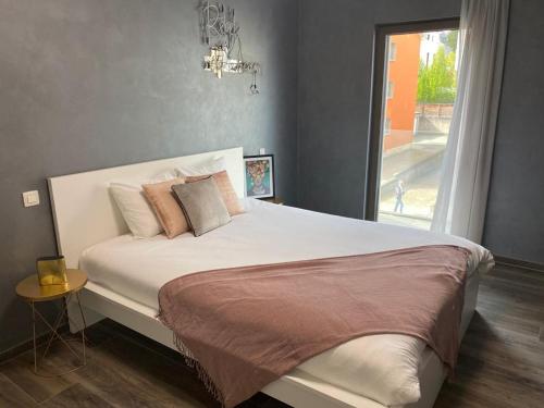 a bedroom with a large bed with a window at Lovely One Bedroom Apartment in City Center with Parking, near Public Transport in Luxembourg