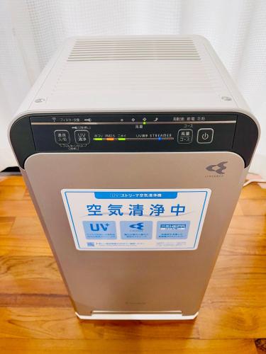 a laptop computer sitting on top of a table at Sunset Beach Vacation House in Chatan