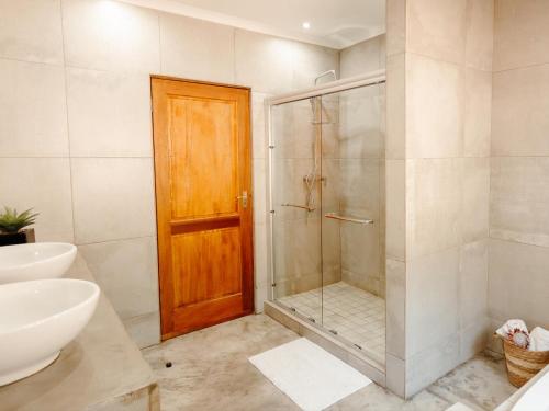 a bathroom with a shower and a glass door at 37 On Anderson in Pretoria