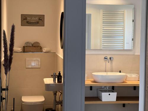 ein Bad mit einem Waschbecken und einem WC in der Unterkunft Ferienwohnung Kohl - Malerhäusl - Berchtesgaden in Berchtesgaden