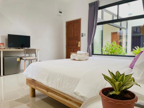 a bedroom with a bed and a large window at Alleyhill Phuket - Private & Cozy Boutique in Phuket Town