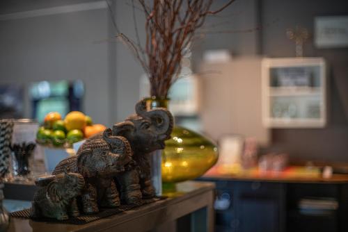 a statue of an elephant on a table with a bowl of fruit at BIG MAMA Berlin in Berlin
