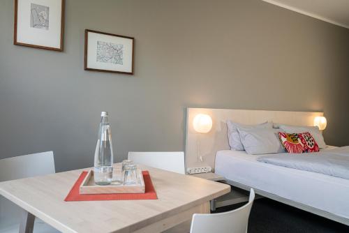 a bedroom with a bed and a table and a table and chairs at BIG MAMA Berlin in Berlin