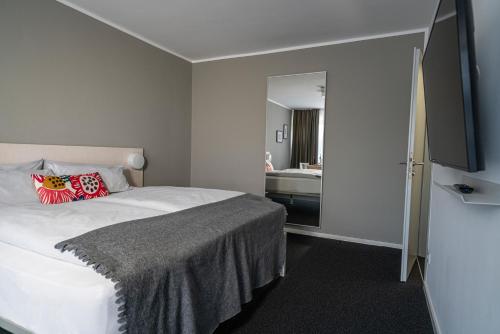 a bedroom with a bed and a bathroom with a sink at BIG MAMA Berlin in Berlin