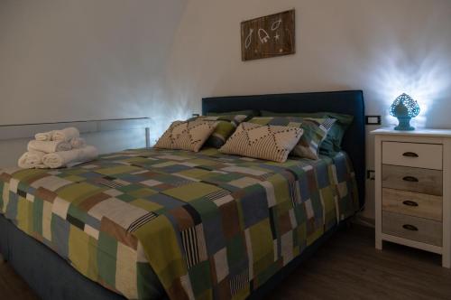 a bedroom with a bed and a night stand at Il Casale di Punta Prosciutto in Punta Prosciutto