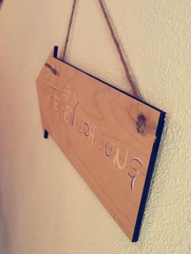 a wooden sign hanging on a wall with the word friendship at Ferienwohnung Reinbrechthof in Anger