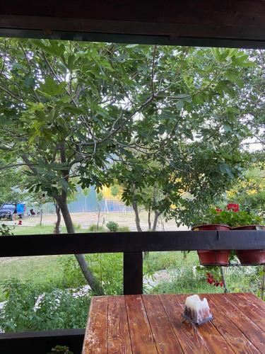 a wooden table with a view of a tree at Agora Farmhouse in Koman