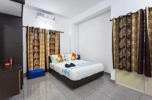 a bedroom with a bed and curtains in a room at Salamath Homestay in Cochin
