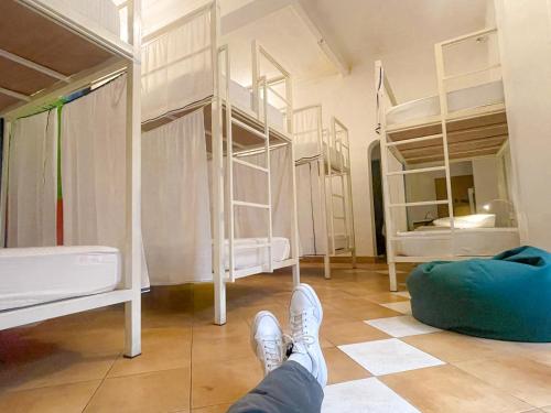 a person standing in a room with bunk beds at Lost & Found - Colombo in Colombo