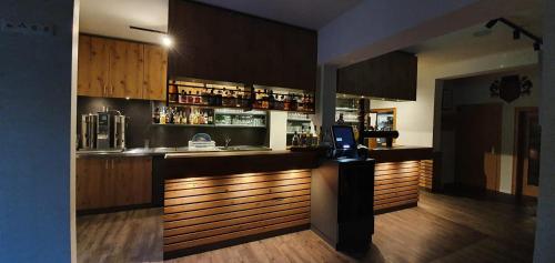a kitchen with a bar with a laptop on the counter at Rhönblick Landhotel - Restaurant - Countrypub in Petersberg