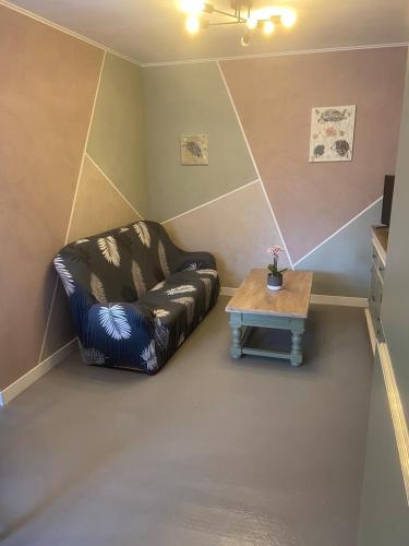 a living room with a couch and a coffee table at Gîtes le Mont Desclos Saint Michel in Beauvoir