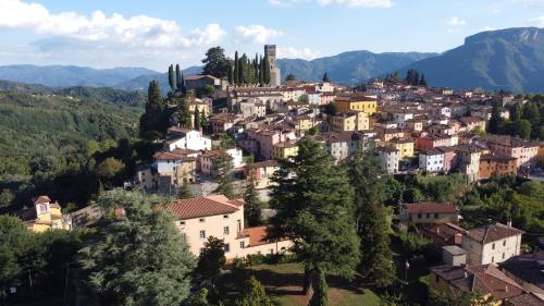 a town on a hill with houses and trees at Villa Gherardi - B&B e Hostel in Barga