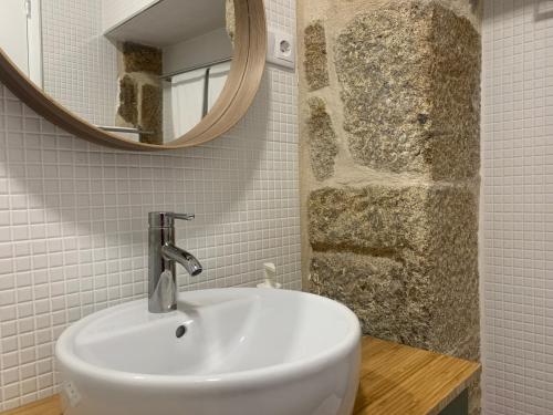 a white sink in a bathroom with a mirror at Casas da Loureira - Casa do Agostinho in Gondarém