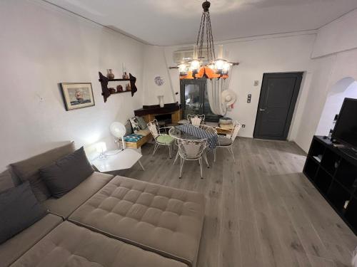 a living room with a couch and a table at Villa Rena In Front of the Sea in Arkoudi