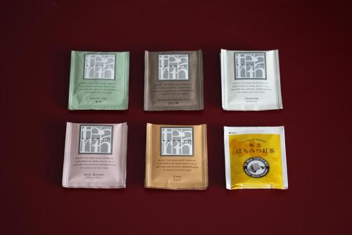 a group of four books on a red background at remm Kagoshima in Kagoshima