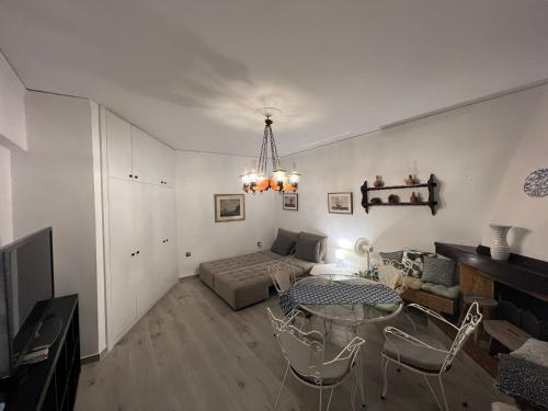 a living room with a table and a couch at Villa Rena In Front of the Sea in Arkoudi