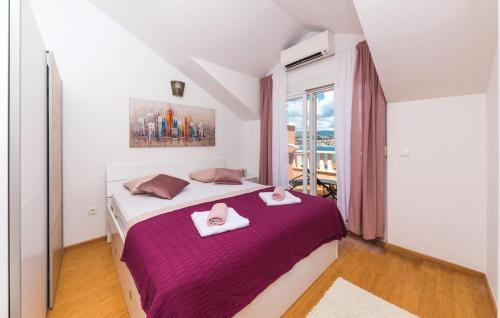 a bedroom with a large bed with two towels on it at Penthouse Dea bye the sea in Okrug Gornji