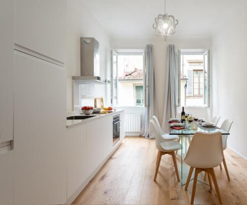 a kitchen and dining room with a table and chairs at Accademia - Flo Apartments in Florence