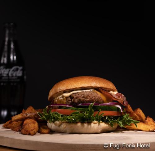 a sandwich sitting on a plate with some food at Fugl Fønix Hotel in Etnesjøen