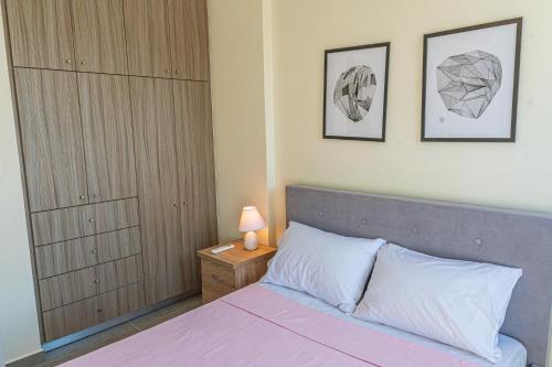 a bedroom with a bed and a closet and a nightstand at Modern, Cheerful & Dream Catching Villa in Corinth in Isthmia
