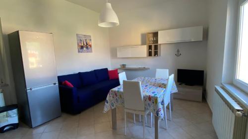 a living room with a table and a blue couch at Da Angela in Il Romito