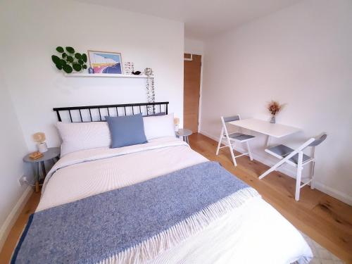 a small bedroom with a bed and a table at Self-contained annexe excellent location in Saltdean