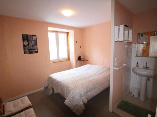 a small bedroom with a bed and a sink at Appartement Lanslebourg-Mont-Cenis, 3 pièces, 5 personnes - FR-1-508-253 in Lanslebourg-Mont-Cenis