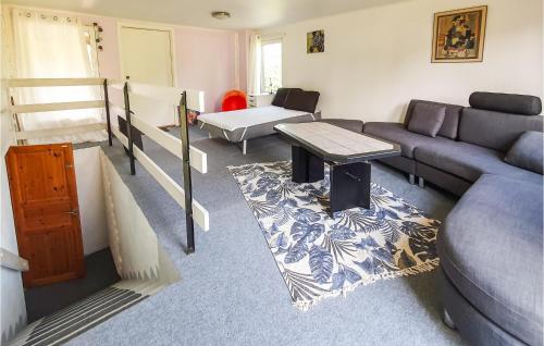 a living room with a couch and a table at 6 Bedroom Pet Friendly Home In Vittaryd in Vittaryd