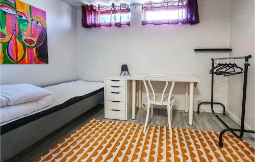 a bedroom with a desk and a bed and a desk and chair at 6 Bedroom Pet Friendly Home In Vittaryd in Vittaryd