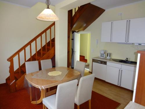 a kitchen and dining room with a table and chairs at Ferienhaus Lohberg in Lohberg