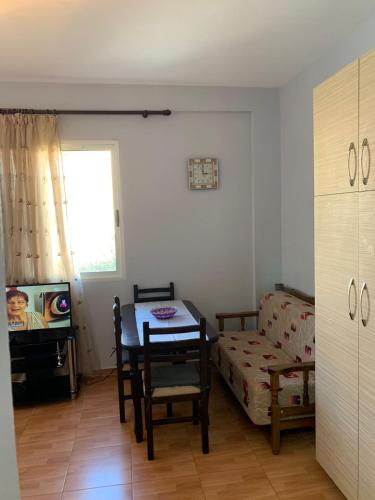 a living room with a table and a couch at Gazi’s Apartament for Rent in Golem