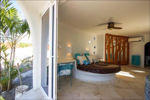 a bedroom with a bed in a room with a window at Alterhome Swan villas with swimming pool and ocean views in Placencia Village