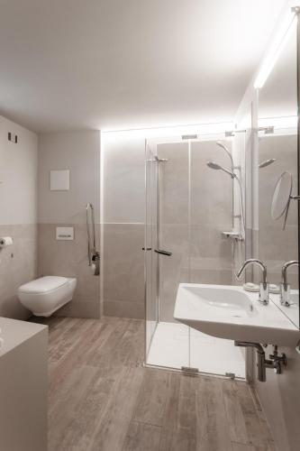 a bathroom with a shower and a sink and a toilet at Locanda MaMaGiò in Valdobbiadene
