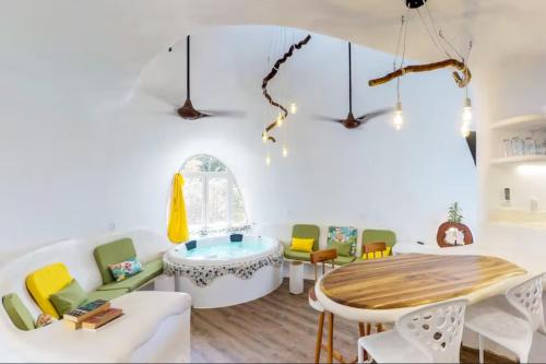 a living room with a table and chairs at Alterhome Swan villas with swimming pool and ocean views in Placencia Village