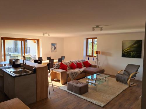 a living room with a couch and a table at Ferme de la Gibussière in Présilly