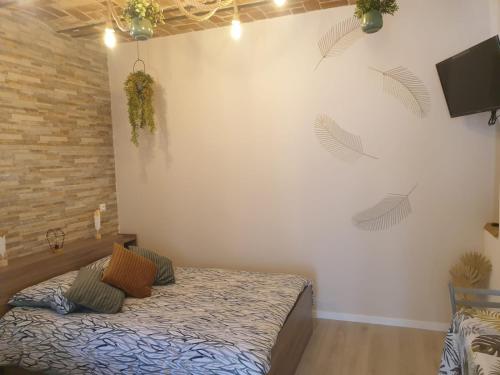 a bedroom with a bed and a brick wall at Charmant logement dans une ancienne ferme in Provins