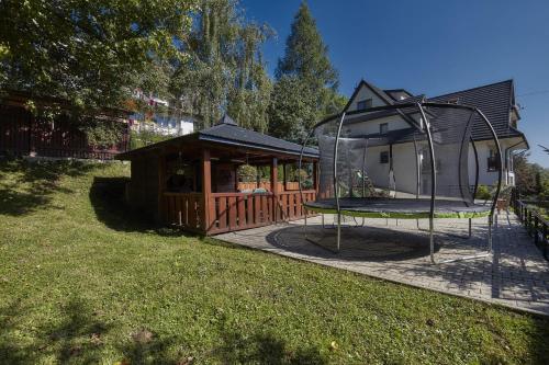 a small house with a playground and a house at New Willa Jan in Zakopane